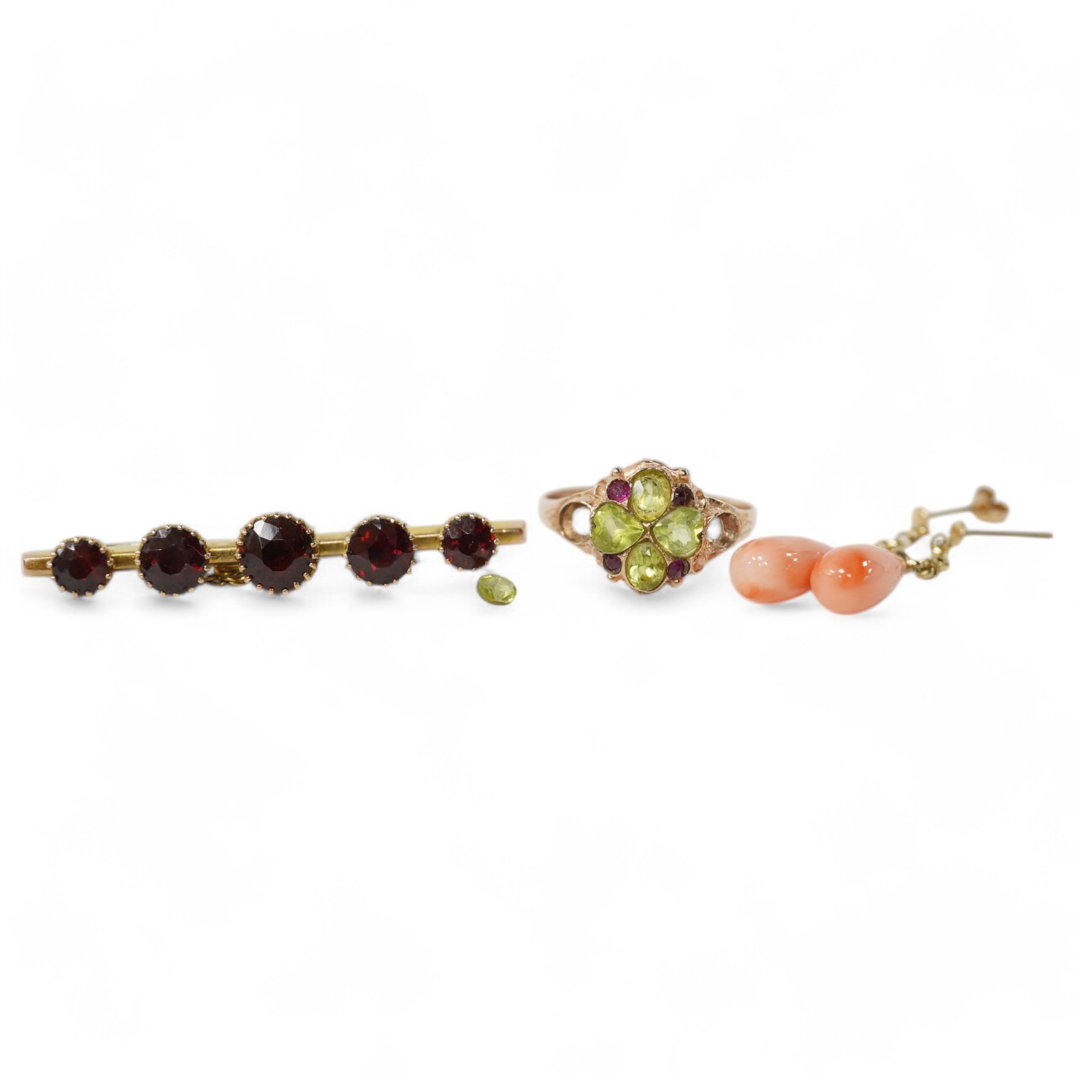 A 9ct gold, peridot and ruby cluster set ring (peridot loose), size P, together with an early 20th century 9ct gold and garnet set bar brooch and a pair of yellow metal and coral set drop earrings, gross weight 5,9 grams